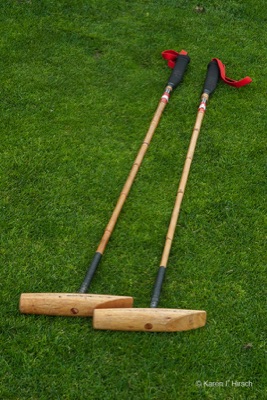 Two polo mallets on the grass